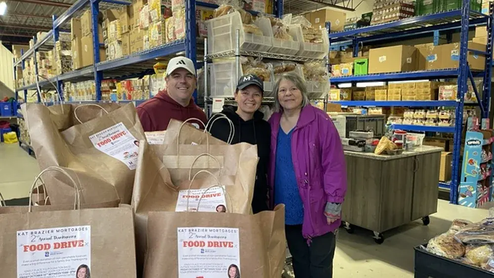 Kat Brazier with volunteers and bagged donations from her 2nd Annual Thanksgiving Food Drive supporting the Georgetown Bread Basket